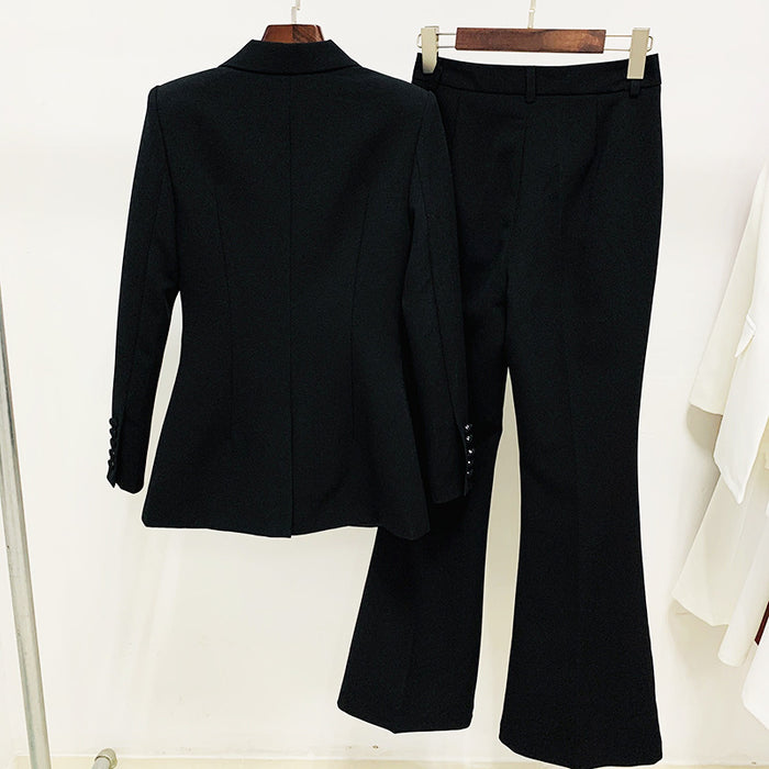Black suit jacket and pants on hangers against a white background