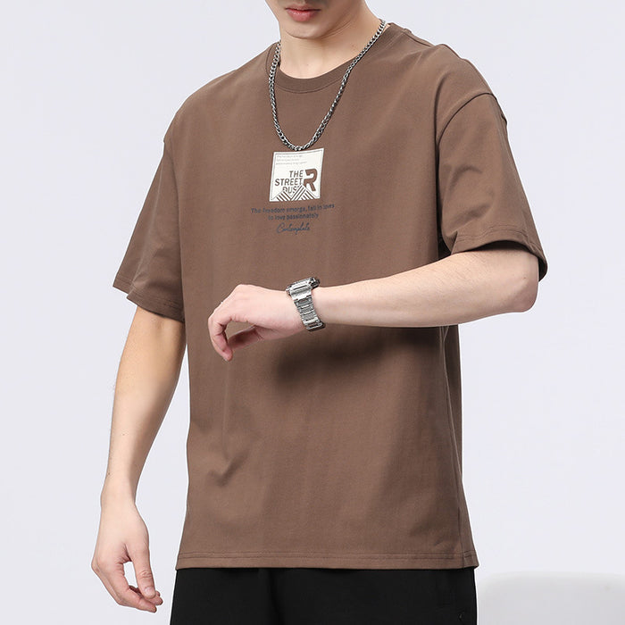 Person wearing a brown t-shirt with a logo on a white background