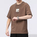Person wearing a brown t-shirt with a logo on a white background