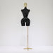Black mannequin torso on a gold stand against a white background