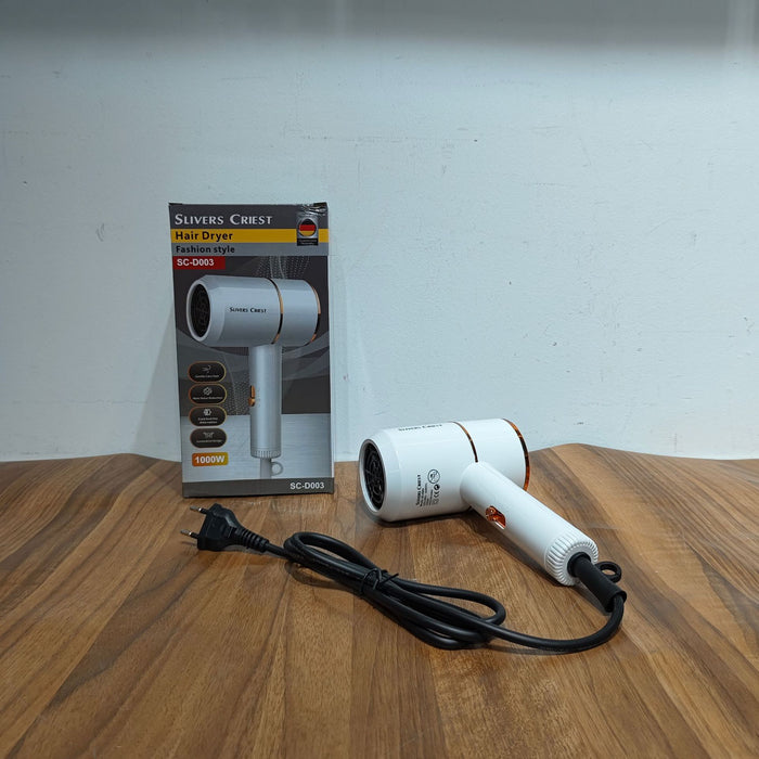 White hair dryer with packaging on a wooden surface