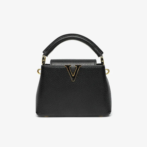 Black handbag with gold accents on a white background