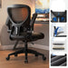 Black office chair with ergonomic features on a wooden floor.