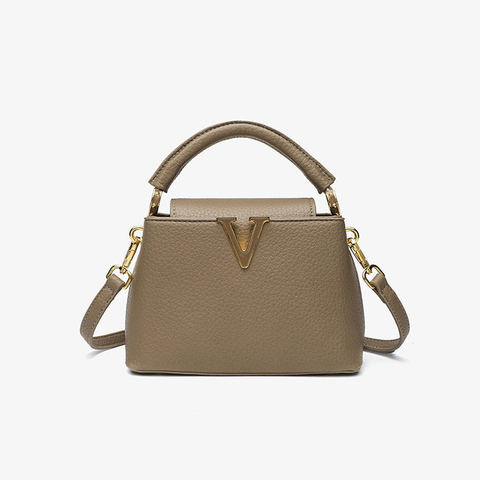 Beige handbag with gold accents on a white background