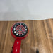 Red hair dryer with a black and silver design on a wooden surface