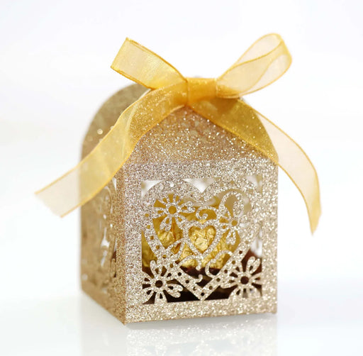 Decorative gold gift box with a yellow ribbon on a white background
