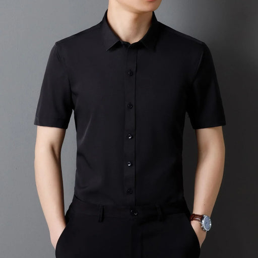 Person wearing a black short-sleeve shirt against a gray background