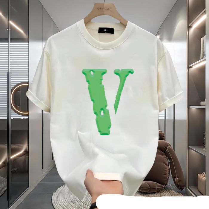 White t-shirt with green logo held in a modern interior setting