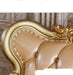 Gold and beige decorative headboard with intricate details on a marble wall background