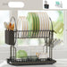 Two-tiered dish rack with various dishes and utensils on a light background