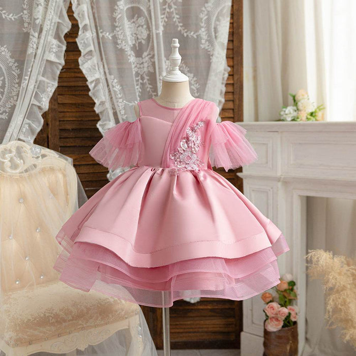 Pink dress on a mannequin against a decorative background