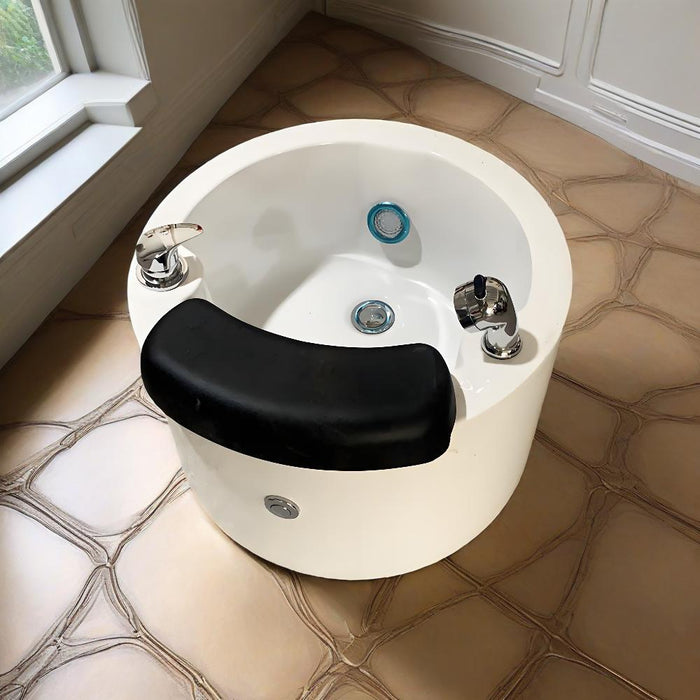 White pedicure chair with black cushion on a tiled floor