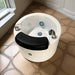 White pedicure chair with black cushion on a tiled floor