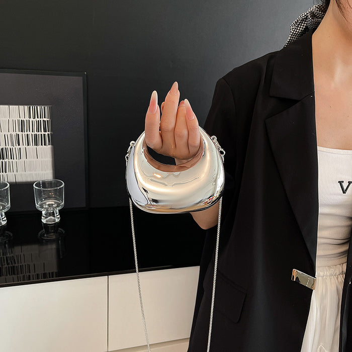 Person wearing a futuristic metallic glove with a black background