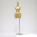 Gold mannequin on a stand against a white background