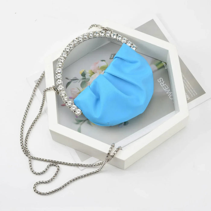 Blue pouch with a chain on a decorative stand