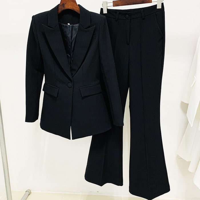 Black suit jacket and pants on hangers against a white background