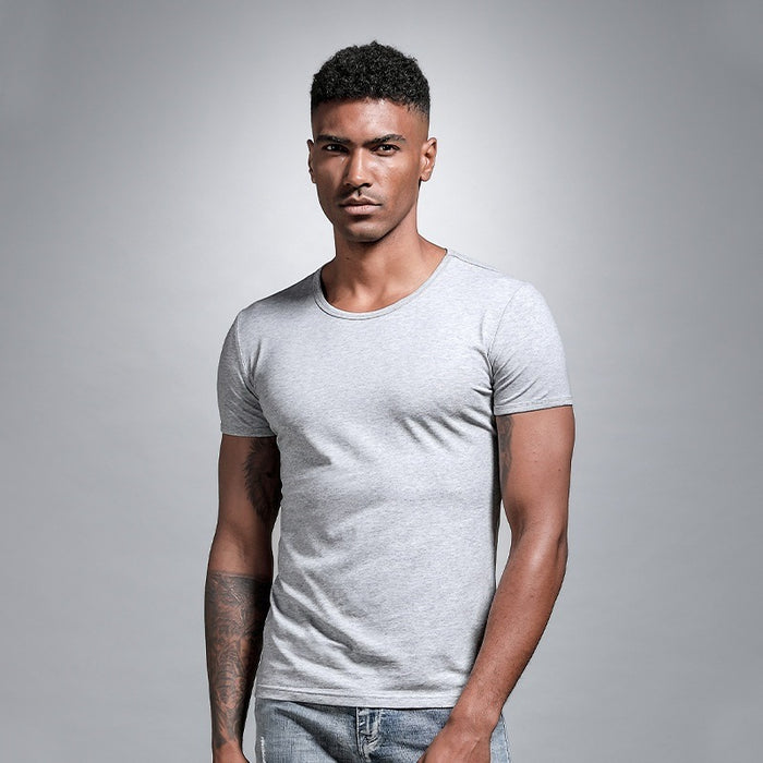 Man wearing a gray t-shirt against a plain background