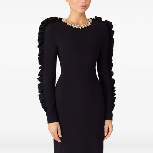 Black dress with ruffled sleeves on a white background