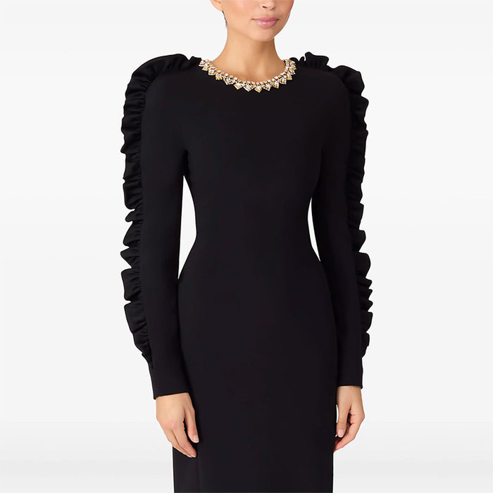 Black dress with ruffled sleeves on a white background