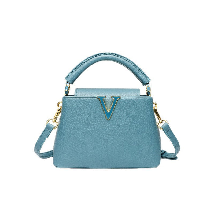 Blue handbag with gold accents on a white background