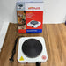 Hot plate with power cord and packaging on a wooden surface