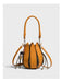 Yellow handbag with decorative elements on a light gray background