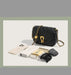 Black handbag with gold chain on a light gray background