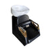 Black and gold hair washing chair with a white basin on a white background