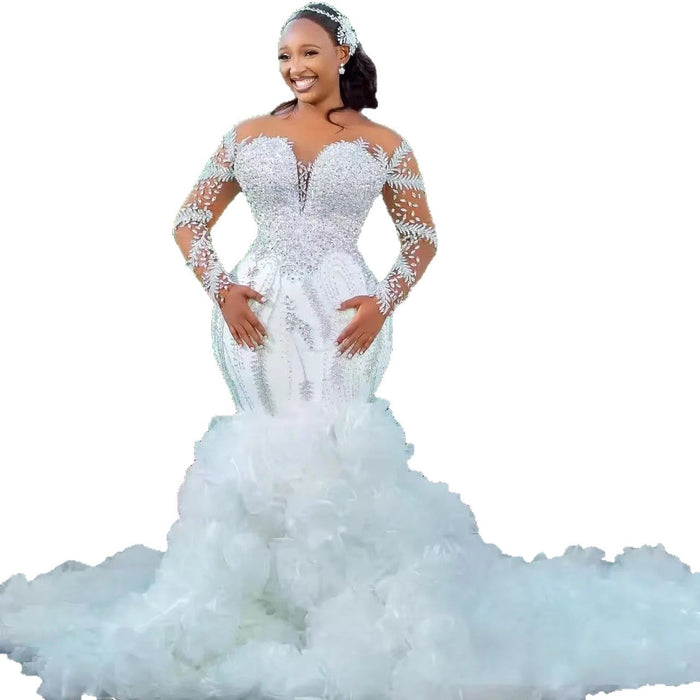 Woman wearing a white wedding dress with a long train on a white background