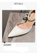 White high-heeled shoe with pearl necklace on a gray surface