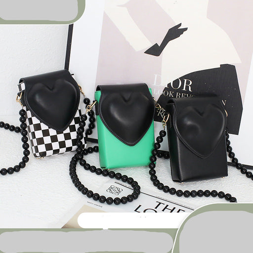 Black heart-shaped phone cases with beaded chains on a white background