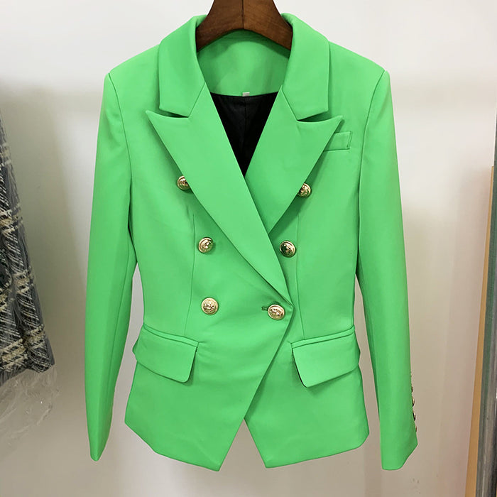 Green blazer with gold buttons on a hanger against a neutral background