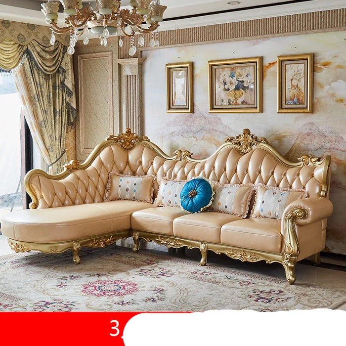 Luxurious beige sofa with gold accents in a decorated room.