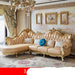 Luxurious beige sofa with gold accents in a decorated room.