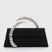Black clutch with a decorative handle on a white background