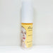 Skincare serum bottle with a yellow label featuring a woman's face on a white background