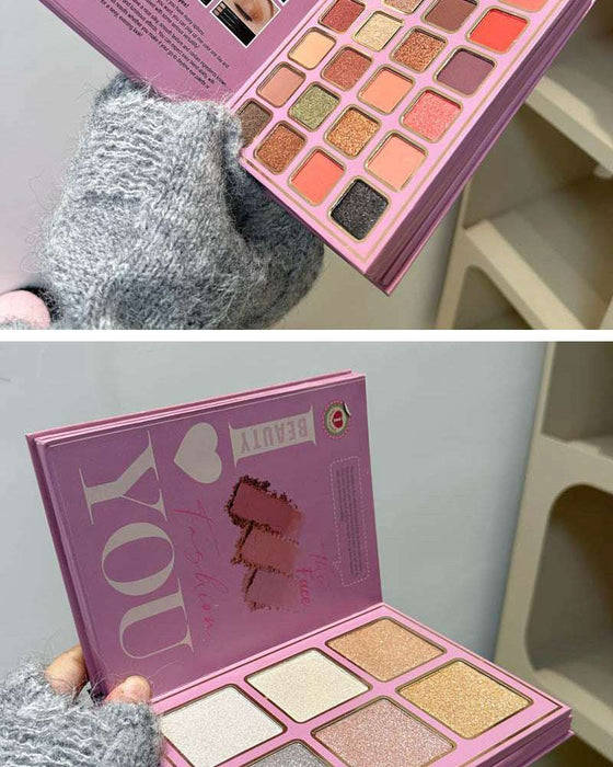 Makeup palette with 'I love you' text held by a person wearing gray gloves.