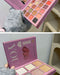 Makeup palette with 'I love you' text held by a person wearing gray gloves.
