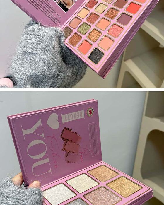 Makeup palette with 'I love you' text held by a person wearing gray gloves.