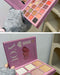 Makeup palette with 'I love you' text held by a person wearing gray gloves.