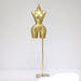 Gold mannequin torso on a stand against a white background