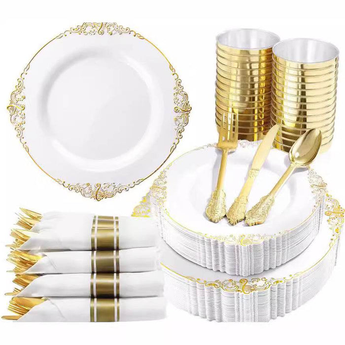 White and gold party supplies including plates, cups, cutlery, and napkins.