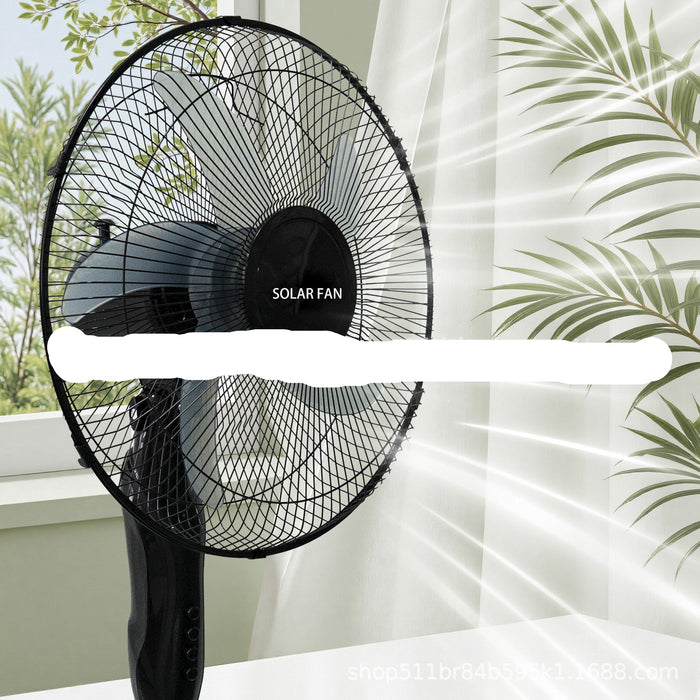 Black solar fan on a white surface with greenery in the background