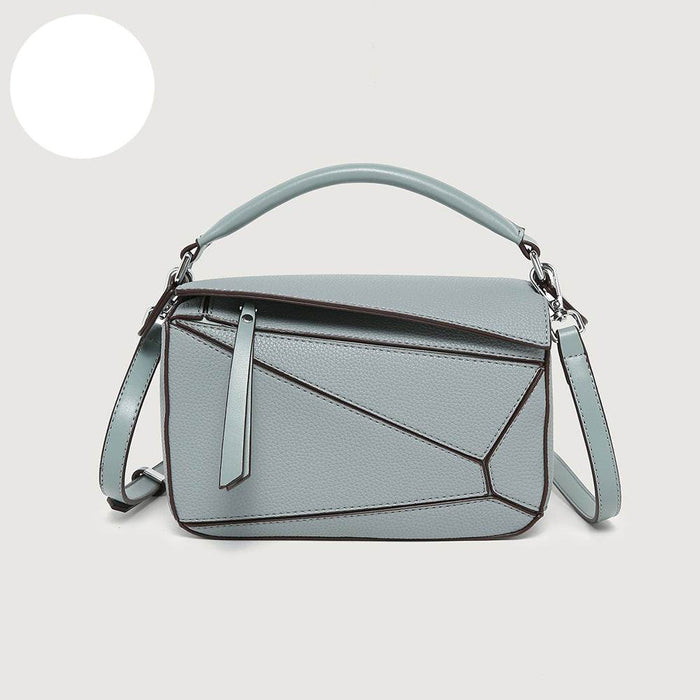 Light blue handbag with geometric design on a white background