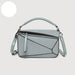 Light blue handbag with geometric design on a white background