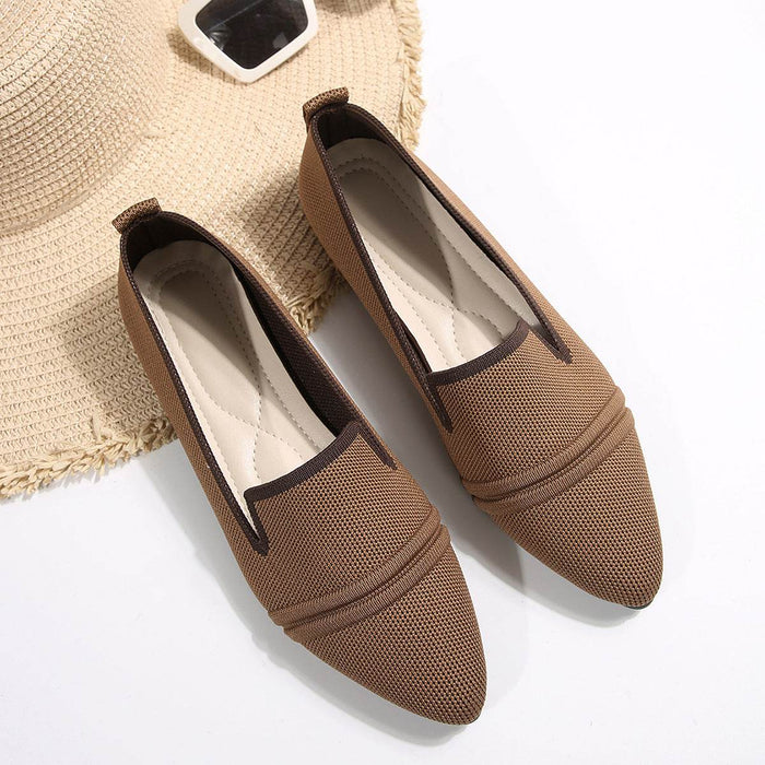 Pair of brown pointed-toe shoes with mesh design on a white background