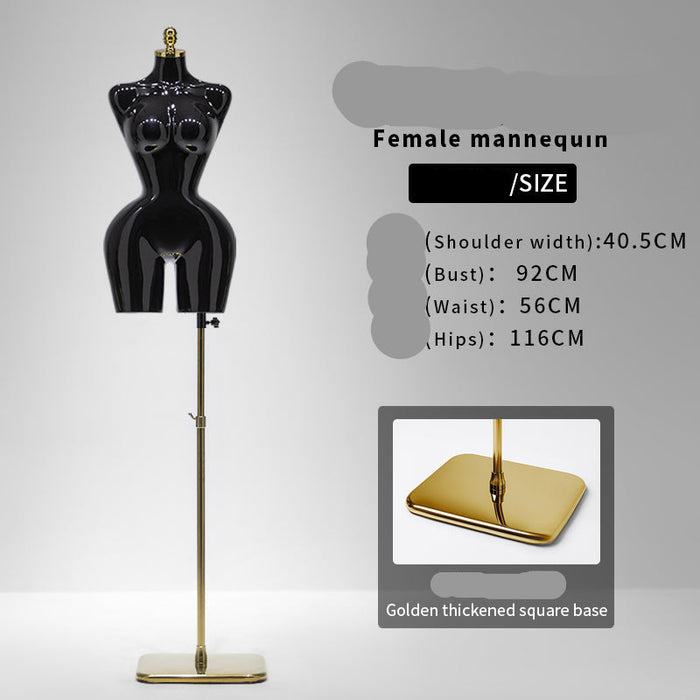 Black female mannequin with gold base on a gray background