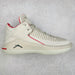 White sneaker with red accents on a light gray background