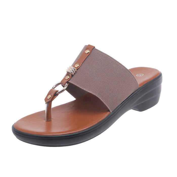 Brown sandal with a thong design on a white background